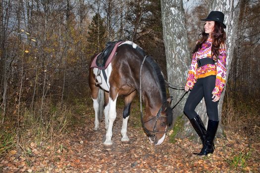 Young woman and horse in a forest