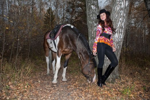 Young woman and horse in a forest