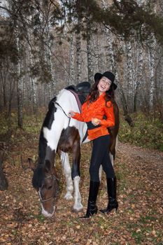 Young woman and horse in a forest