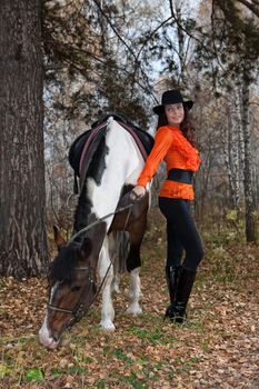 Young woman and horse in a forest