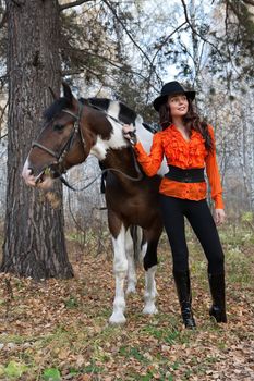 Young woman and horse in a forest