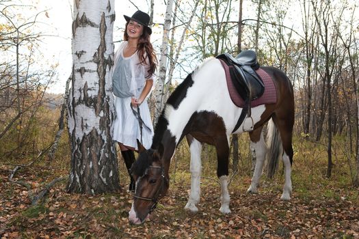 Young woman and horse in a forest