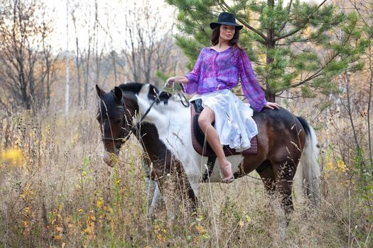 Young woman and horse in a forest