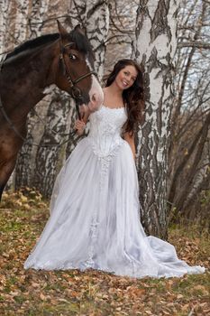 Young woman and horse in a forest