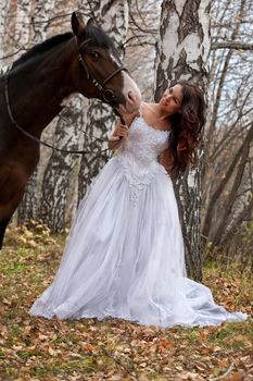 Young woman and horse in a forest