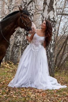 Young woman and horse in a forest