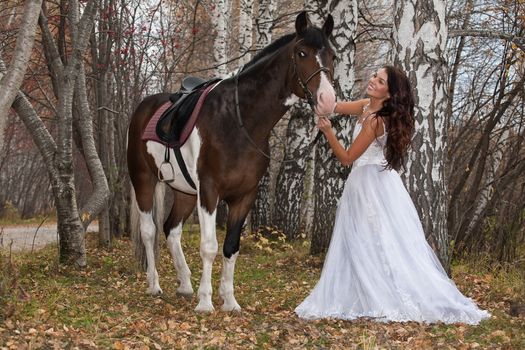 Young woman and horse in a forest