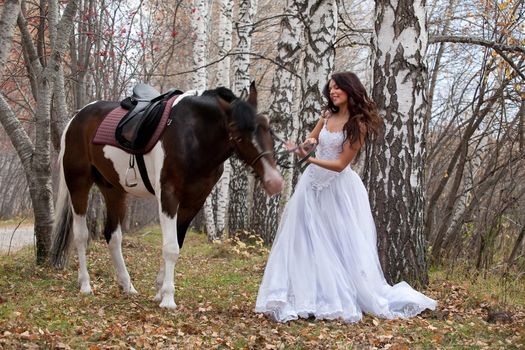 Young woman and horse in a forest