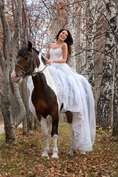 Young woman and horse in a forest