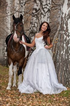 Young woman and horse in a forest