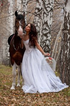 Young woman and horse in a forest