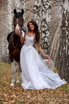 Young woman and horse in a forest