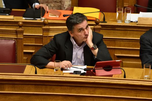 GREECE, Athens : Greece's Finance Minister Euclid Tsakalotos attends a parliamentary session ahead of a voting, in Athens, Greece December 15, 2015. Greek parliament votes on reforms needed for the country to receive further financial aid from its international lenders.