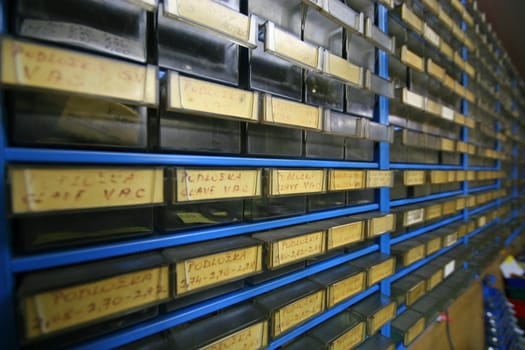 Workshop wall where all parts are organised in boxes