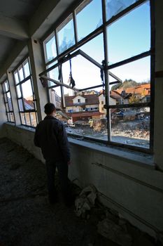 Man looking at modern ruins