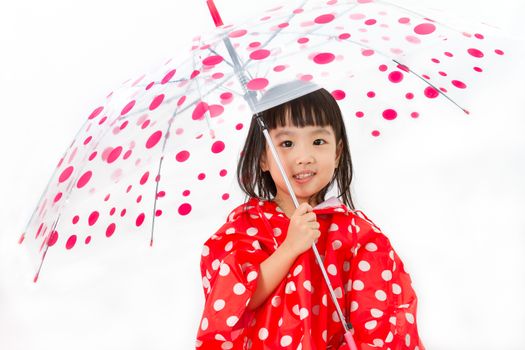 Chinese Little Girl Holding umbrella with raincoat in plain white isolated background.