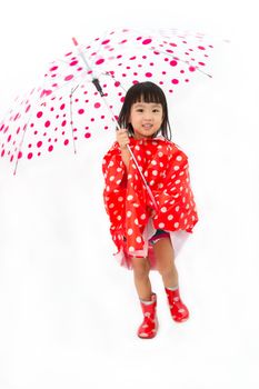 Chinese Little Girl Holding umbrella with raincoat in plain white isolated background.