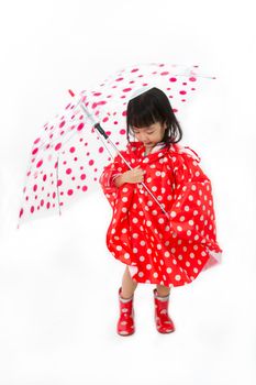 Chinese Little Girl Holding umbrella with raincoat in plain white isolated background.
