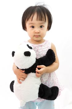 Chinese Little Girl Holding Panda Toy in plain white isolated background.