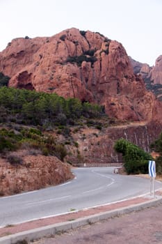Road and red cliffs in Provence, France