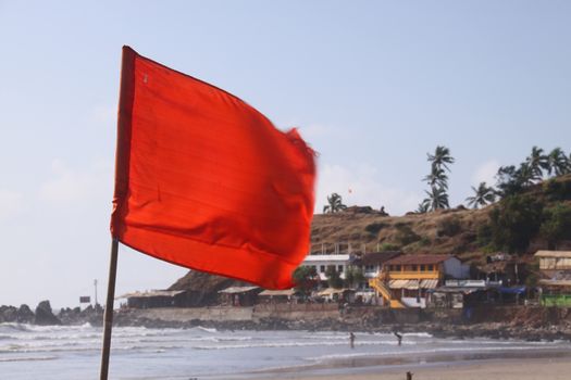 Red flag on the beach - it means: "High hazard. Rough conditions such as strong surf and/or currents are present. All swimmers are discouraged from entering the water. Those entering the water should take great care."