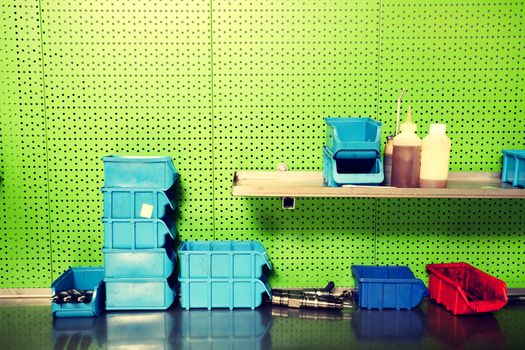 Workshop wall where all parts are organised in boxes