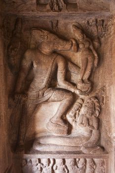 Cave temple cut out from the rock at Badami, India - relief at the Vaishnava cave temple no. 2