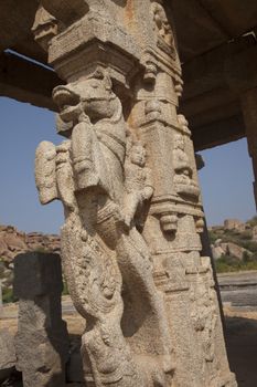 Pillar with a horse motif in Hampi temple complex in Karnataka, India