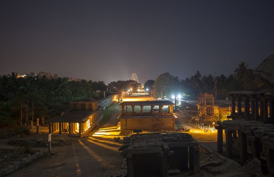 Ruins at night, at the far side Virupaksha - Vijayanagar Temple - at Hampi temple complex in India