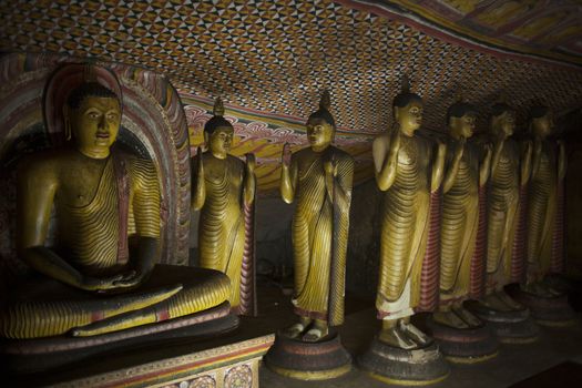 Group of statues inside Dambula cave temple in Sri Lanka. Indoors.