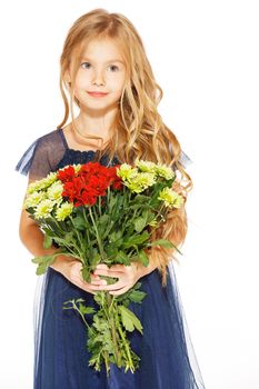 Charming little girl with curly hair in a blue dress with a bouquet of flowers