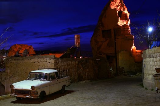 Old car in wonderful land of Cappadokia in Turkey with amaizing sky
