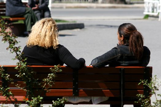 Two women sitting and chating in the park
