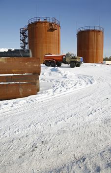 Tank storage crude Oil and fuel truck in winter landscape