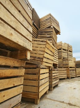 Plenty of empty wooden boxes standing on top of each other