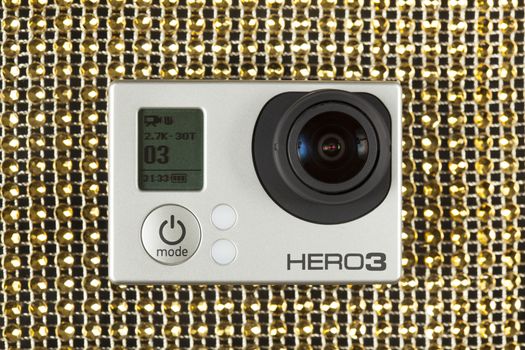 GoPro Hero 3 on golden colour pattern.
