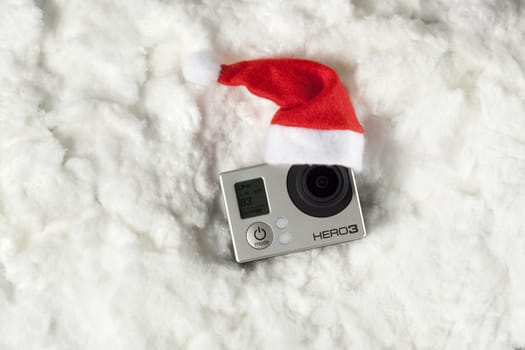 High angle view of camera on cotton with santa hat