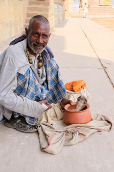 Varanasi, India - October 30, 2009: Snake charmer on the streets of Varanasi.