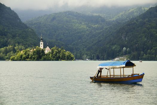 Castle by the Lake Bled in Slovenia and traditional tourist boat
