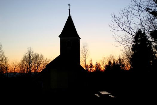 Silhouette of a church at sunset