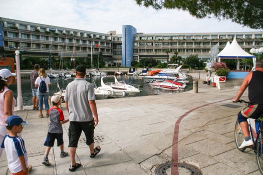 People walking on a promenade in Slovenian coast.