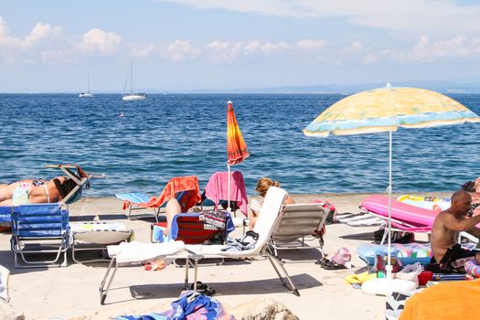 Sunbathing on a beach in Piran, Slovenia