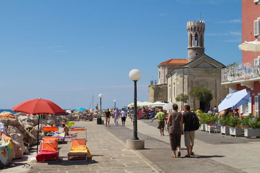 People walking on a promenade in Prian, SLovenia.