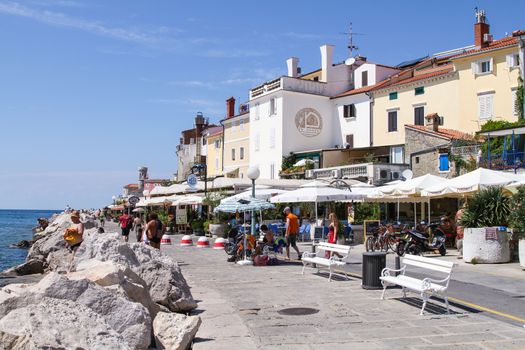 People walking on a promenade in Prian, SLovenia.