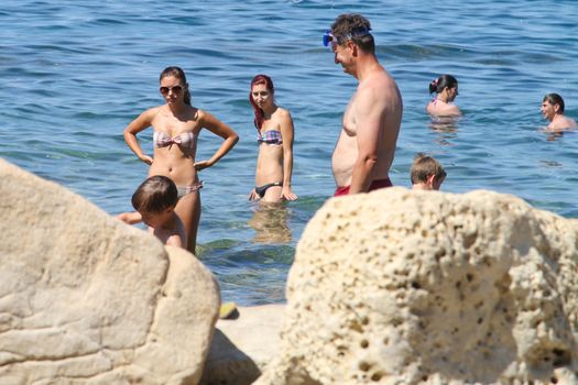 Sunbathing on a beach in Piran, Slovenia