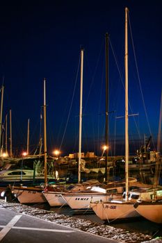 Marine at dusk with fishing boats and yachts.