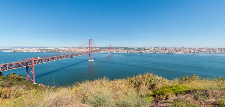 Panoramic view of 25th of April Suspension Bridge over the Tagus river in Lisbon, Portugal