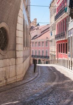 Old narrow street in Alfama district in Lisbon, Portugal