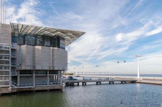 Riverfront in Lisbon Park of Nations with cable car and Vasco da Gama Bridge in the background