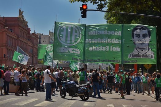 ARGENTINA, Buenos Aires: Demonstrators march in Buenos Aires, on February 1, 2016, waving flags and banners.The march took place near the Ministry of Defense of Argentina and protesters called for the workers to get their jobs back.